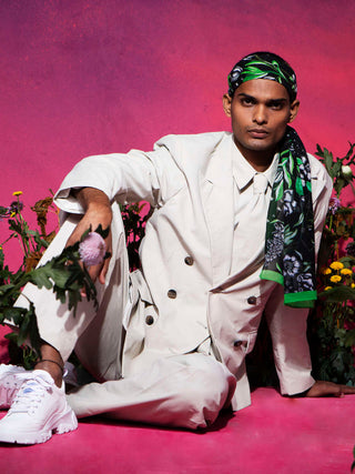 Trendy man wearing luxury silk scarf with green floral pattern and white flowers